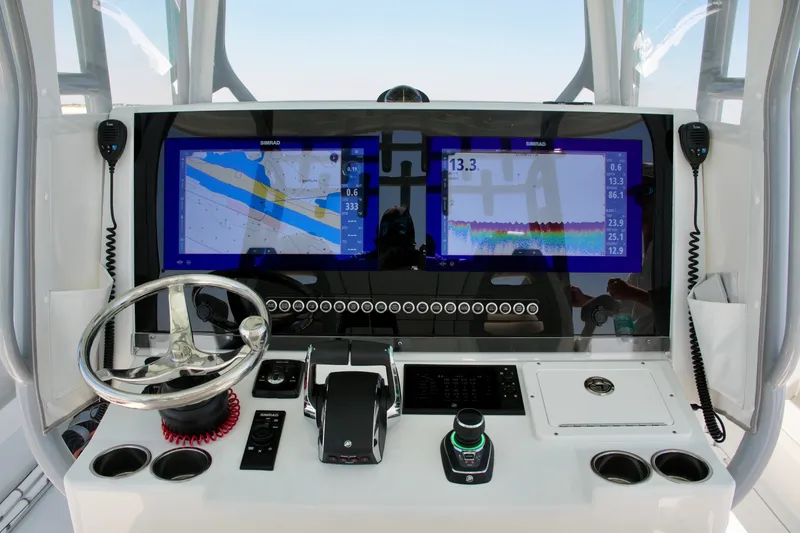 Slide: The Image of Helm of 2024 Freeman 38 boat with advanced navigation displays and controls. - 12