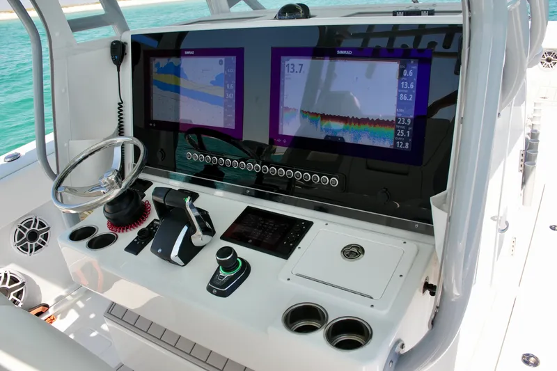 Slide: The Image of 2024 Freeman 38 boat dashboard with dual Simrad displays and modern controls. - 13