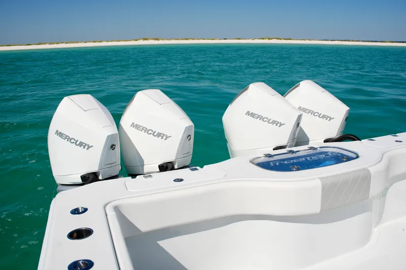 Slide: The Image of 2024 Freeman 38 boat with four Mercury outboard engines on turquoise water. - 22