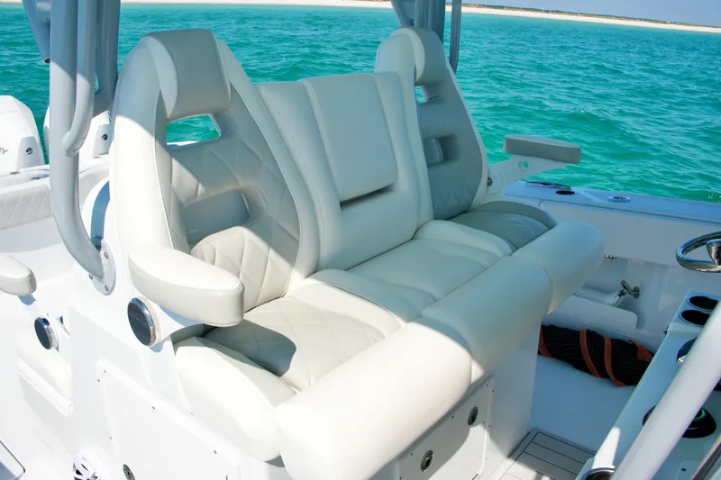 Slide: The Image of Luxurious seating on a 2024 Freeman 38 boat, with ocean backdrop. - 15