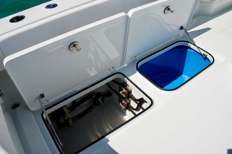 Slide: The Image of Open storage compartments on a 2024 Freeman 38 boat, featuring a blue interior. - 25