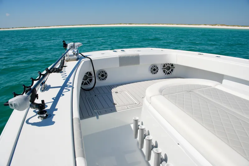 Slide: The Image of 2024 Freeman 38 boat interior with seating, rod holders, and ocean view. - 28