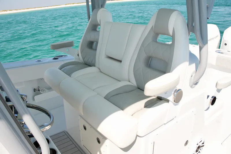 Slide: The Image of Luxurious seating on a 2024 Freeman 38 boat, featuring plush white upholstery and ocean backdrop. - 16