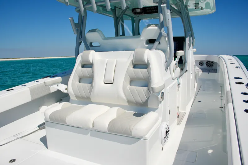 Slide: The Image of 2024 Freeman 38 boat interior with luxurious white seating and ocean backdrop. - 20