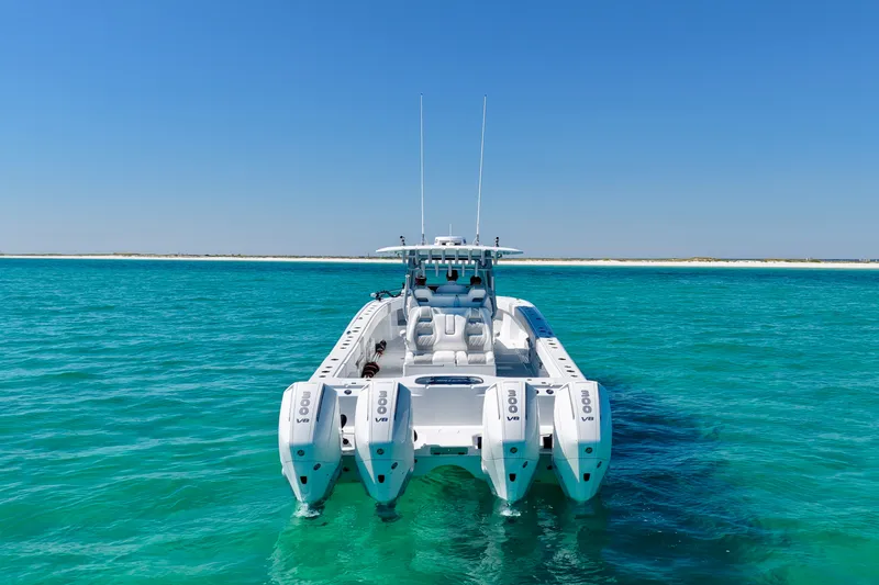 Slide: The Image of 2024 Freeman 38 boat with quad engines on turquoise water under clear blue sky. - 7