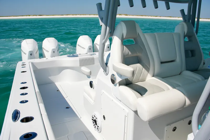 Slide: The Image of 2024 Freeman 38 boat with luxurious seating and powerful Mercury engines on turquoise water. - 17