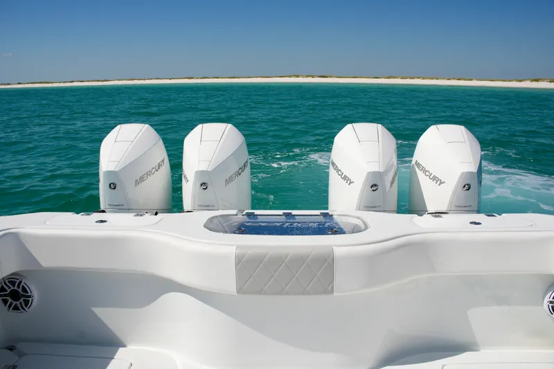 Slide: The Image of Freeman 38 boat with four Mercury engines on turquoise water, 2024 model. - 23