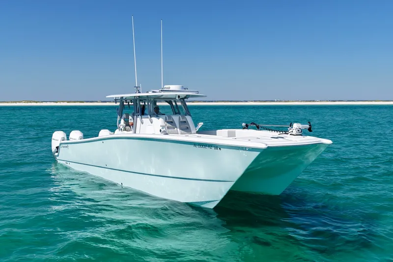 Slide: The Image of 2024 Freeman 38 boat cruising on clear blue water under a sunny sky. - 3