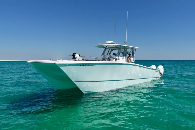 Slide: The Image of 2024 Freeman 38 boat cruising on clear turquoise water under a bright blue sky. - 4