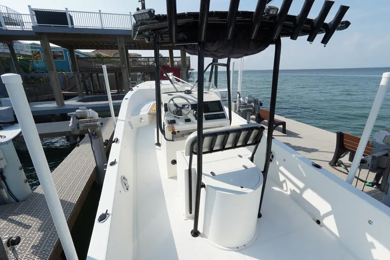 Slide: The Image of 2021 Cortez 31 Super Panga boat docked by the ocean, featuring a sleek design and spacious deck. - 11