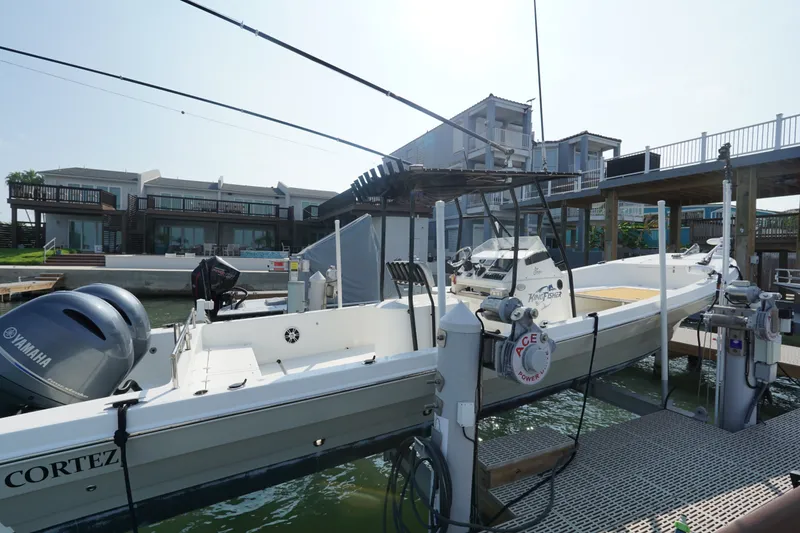 Slide: The Image of 2021 Cortez 31 Super Panga boat docked with Yamaha engine, waterfront view. - 2