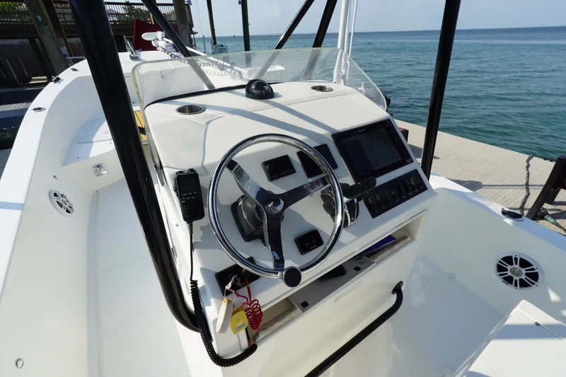 Slide: The Image of 2021 Cortez 31 Super Panga boat cockpit with steering wheel and control panel. - 10