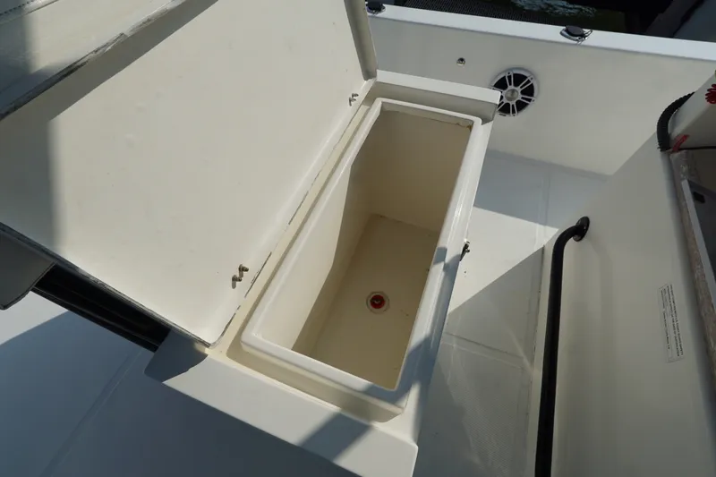 Slide: The Image of Open storage compartment on 2021 Cortez 31 Super Panga boat deck. - 13