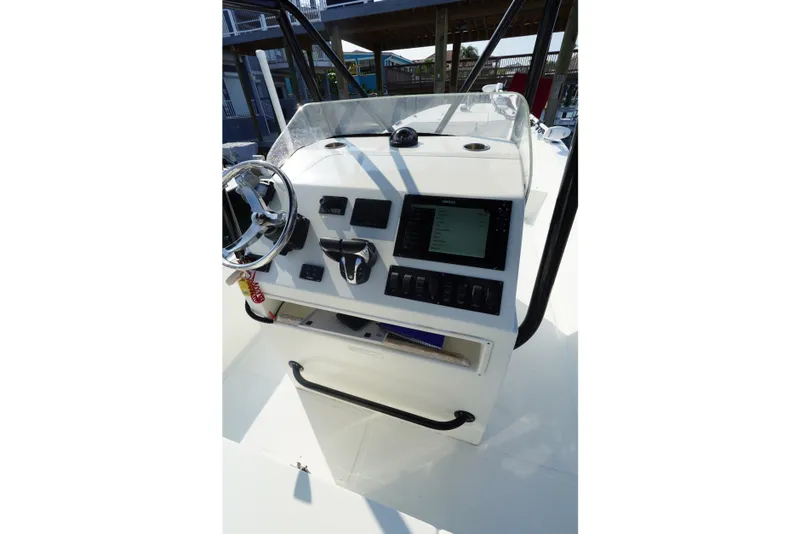 Slide: The Image of Helm of 2021 Cortez 31 Super Panga boat with steering wheel and control panel. - 15