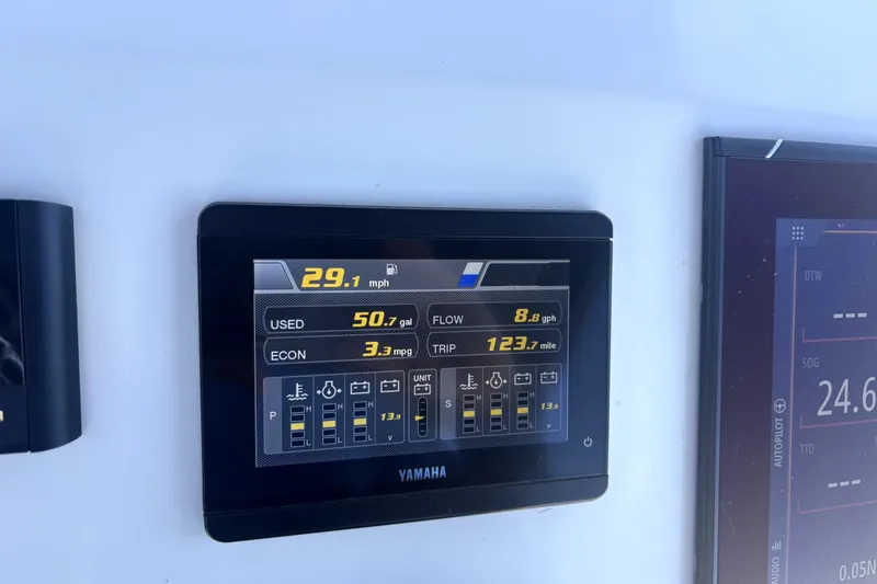Slide: The Image of Yamaha display on 2021 Cortez 31 Super Panga showing speed, fuel usage, and trip data. - 32