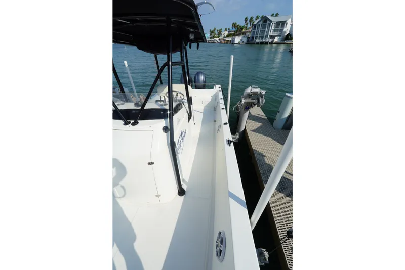 Slide: The Image of 2021 Cortez 31 Super Panga boat docked by waterfront homes. - 18