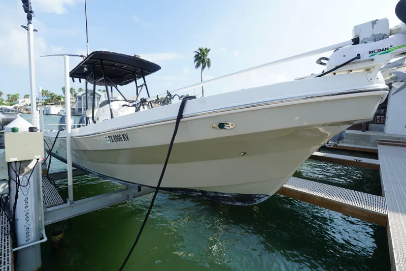 Slide: The Image of 2021 Cortez 31 Super Panga boat docked on a lift in a marina. - 1