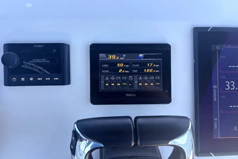 Slide: The Image of Boat dashboard with Yamaha display, Fusion audio controls, and navigation screen on Cortez 31 Super Panga. - 35