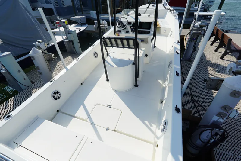 Slide: The Image of 2021 Cortez 31 Super Panga boat docked, showcasing spacious deck and modern controls. - 8