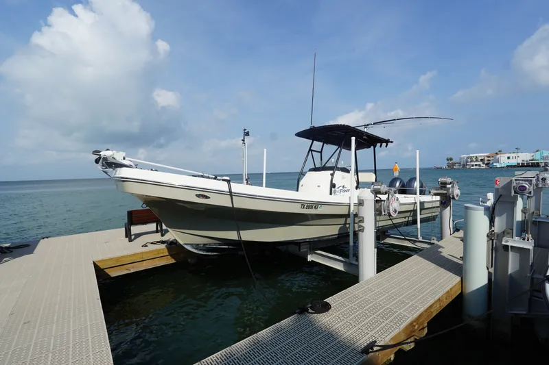 Slide: The Image of 2021 Cortez 31 Super Panga boat docked by the ocean under a clear sky. - 3