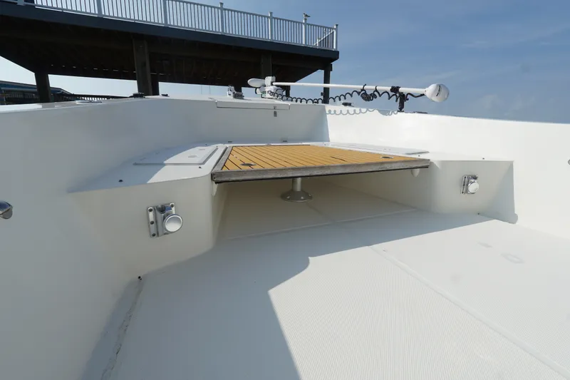 Slide: The Image of 2021 Cortez 31 Super Panga boat deck with wooden platform and railing. - 5