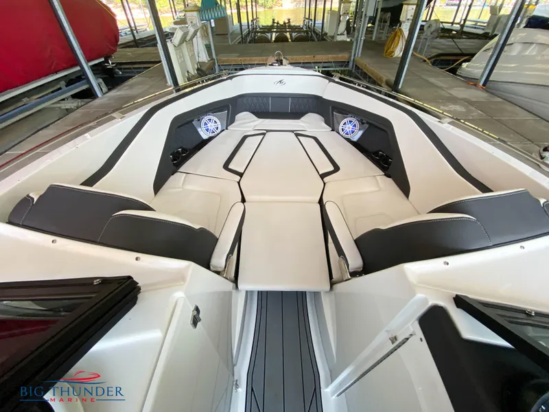 Slide: The Image of 2023 Monterey 298SS boat interior with white and black seating, speakers, and Big Thunder Marine logo. - 32