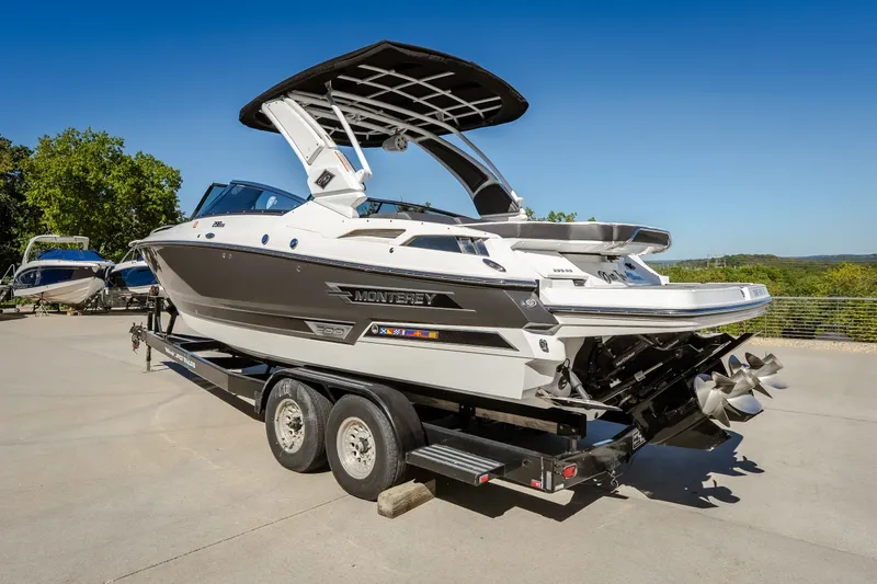 The Image of 2023 Monterey 298SS Super Sport boat on trailer, sleek design, outdoor setting. - 0