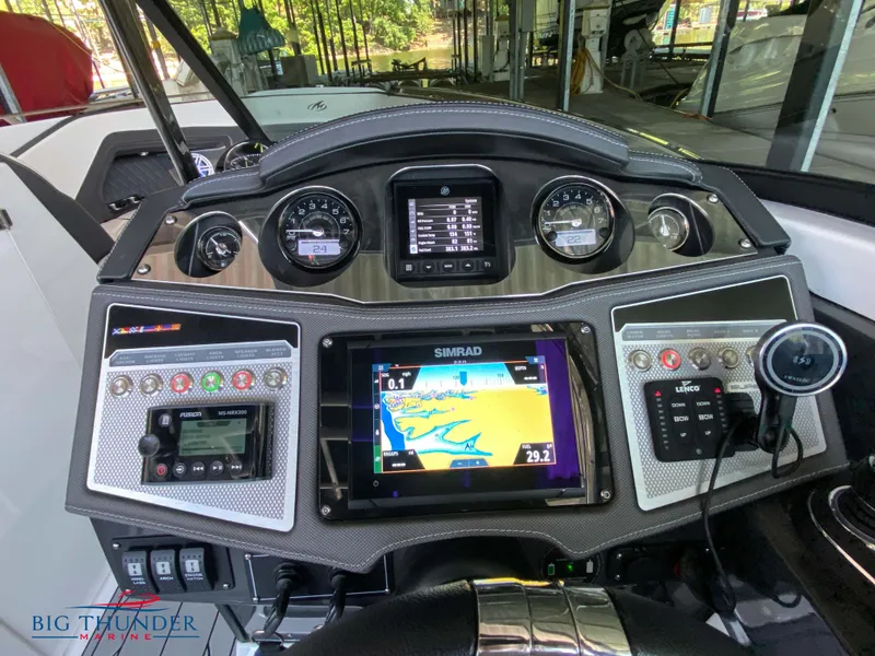 Slide: The Image of 2023 Monterey 298SS boat dashboard with Simrad navigation system and control panel. - 18