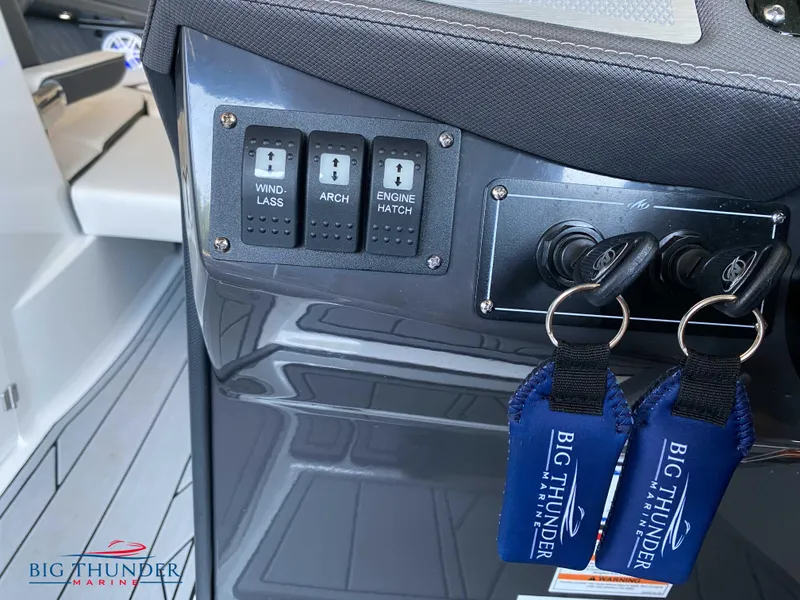 Slide: The Image of Control panel of a 2023 Monterey 298SS boat with Big Thunder Marine keychains. - 24