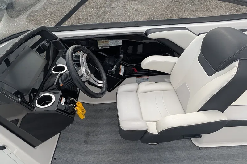 Slide: The Image of 2019 Yamaha Boats 242 Limited S cockpit with steering wheel and comfortable seating. - 14