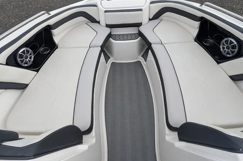 Slide: The Image of 2019 Yamaha Boats 242 Limited S interior with sleek seating and built-in speakers. - 18