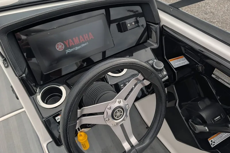 Slide: The Image of 2019 Yamaha Boats 242 Limited S dashboard with steering wheel and touchscreen display. - 15