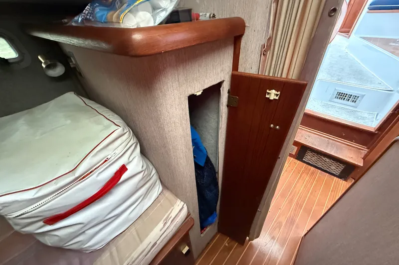 Slide: The Image of Interior of 1987 Bayliner 3270 Motoryacht with storage area and wooden flooring. - 31