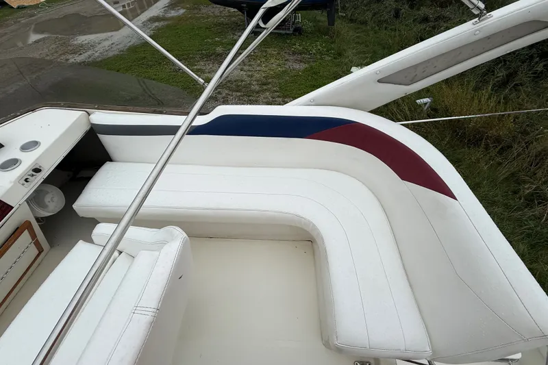 Slide: The Image of 1987 Bayliner 3270 Motoryacht interior with white seating and colorful accents. - 14