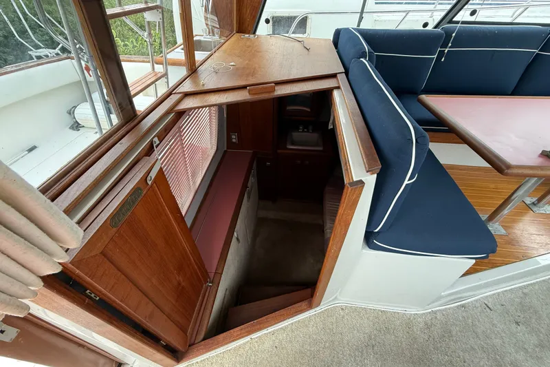 Slide: The Image of 1987 Bayliner 3270 Motoryacht interior with wooden stairs and blue cushioned seating. - 20