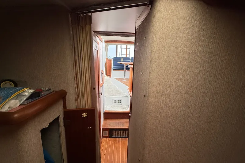 Slide: The Image of Interior view of 1987 Bayliner 3270 Motoryacht, featuring hallway and seating area. - 32