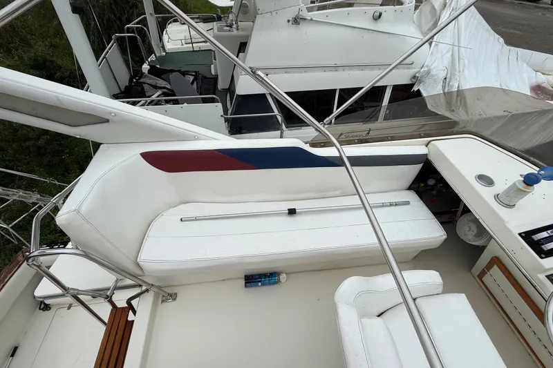 Slide: The Image of 1987 Bayliner 3270 Motoryacht cockpit with white seating and control panel. - 15