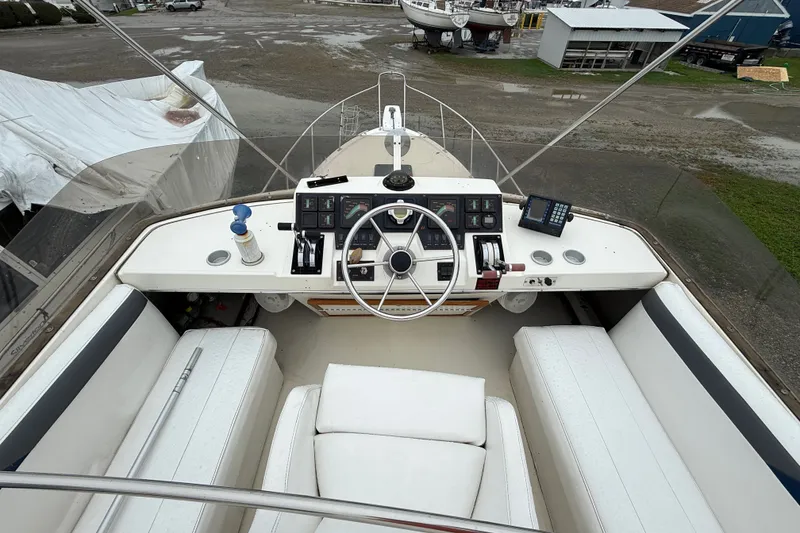 Slide: The Image of 1987 Bayliner 3270 Motoryacht helm with steering wheel, controls, and seating. - 13