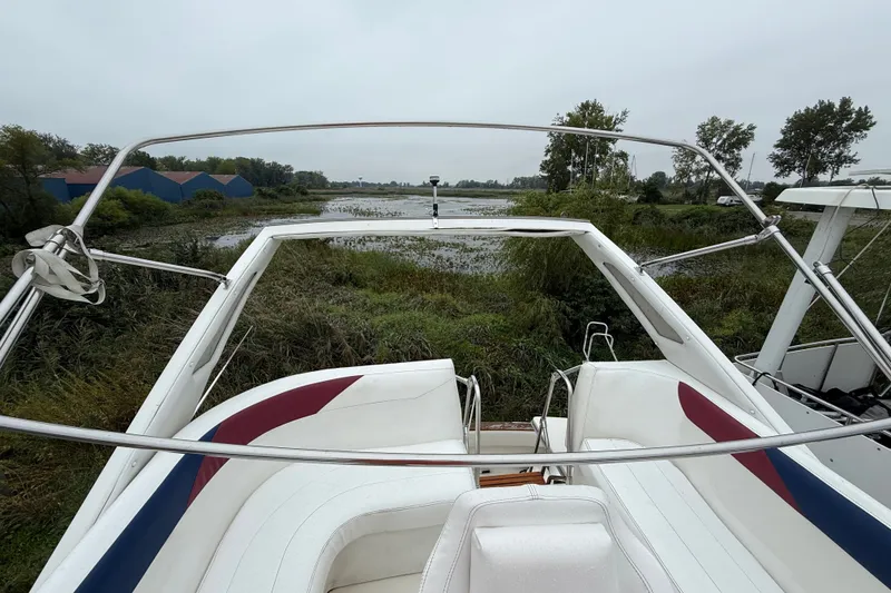 Slide: The Image of 1987 Bayliner 3270 Motoryacht overlooking serene waterway with lush greenery. - 18