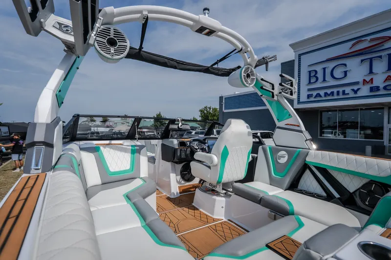 Slide: The Image of 2021 Tigé 21ZX boat interior with modern seating and audio system at a dealership. - 16