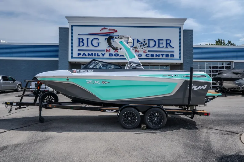 Slide: The Image of 2021 Tigé 21ZX boat on trailer at Big Thunder Marine dealership. - 1