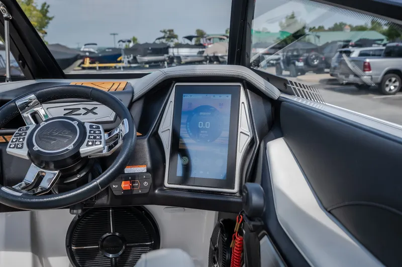 Slide: The Image of 2021 Tigé 21ZX boat dashboard with touchscreen display and steering wheel. - 24