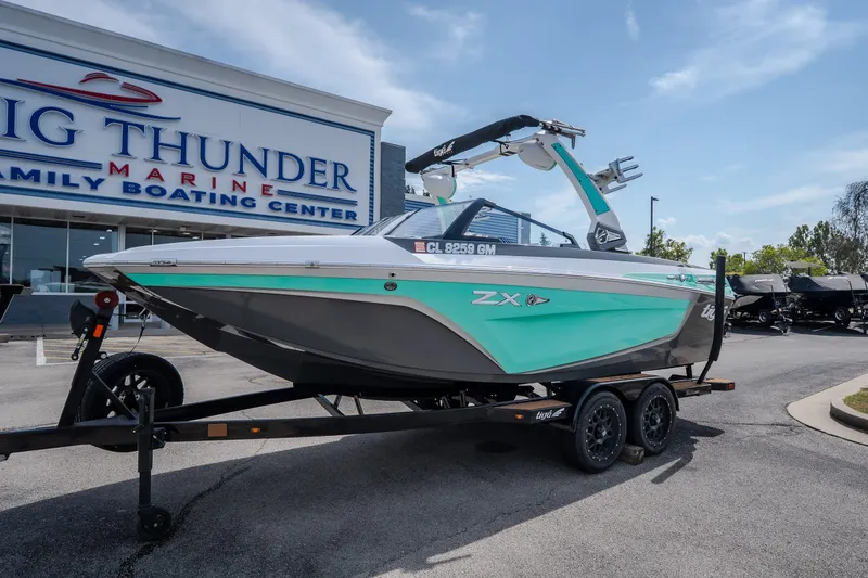 Slide: The Image of 2021 Tigé 21ZX boat on trailer at Big Thunder Marine dealership. - 6