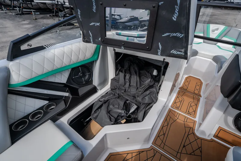 Slide: The Image of 2021 Tigé 21ZX boat interior with stylish seating and storage compartment. - 31