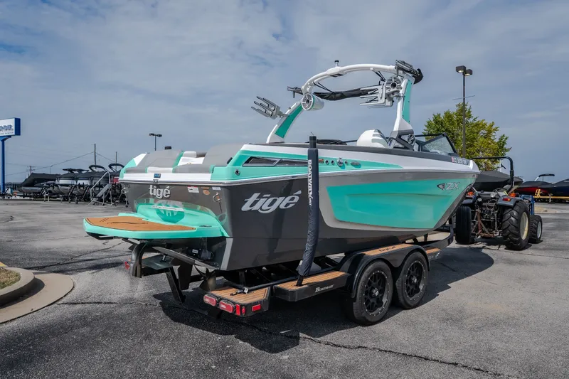 Slide: The Image of 2021 Tigé 21ZX boat on trailer, featuring sleek design and vibrant turquoise accents. - 51