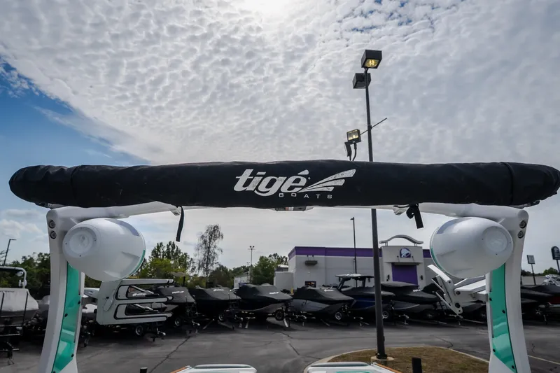 Slide: The Image of 2021 Tigé 21ZX boat with speakers, under a cloudy sky at a dealership. - 41