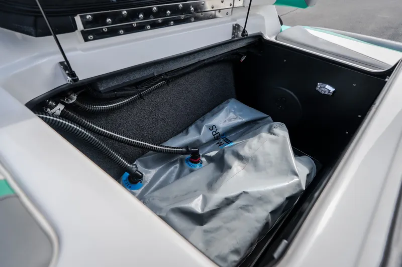 Slide: The Image of 2021 Tigé 21ZX boat storage compartment with ballast bag and hoses. - 29
