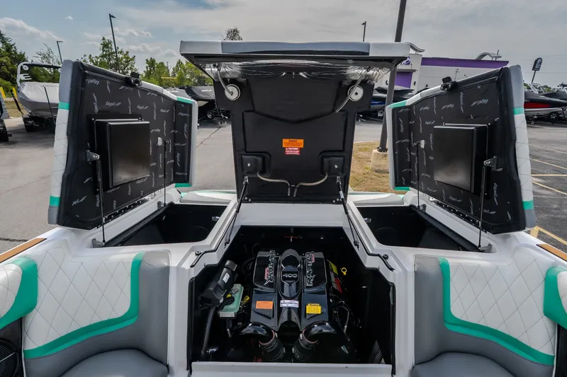 Slide: The Image of 2021 Tigé 21ZX boat engine compartment with open hatches, showcasing interior design and engine details. - 25