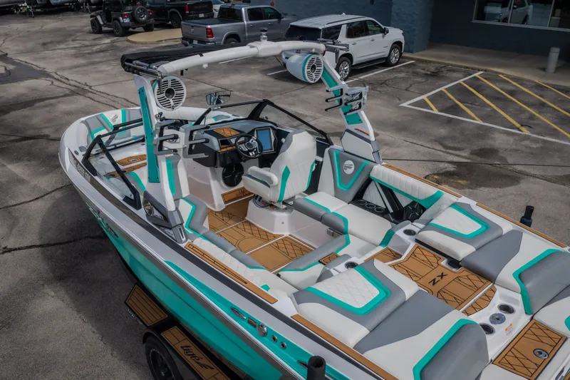Slide: The Image of 2021 Tigé 21ZX boat with modern interior design and vibrant teal accents. - 48