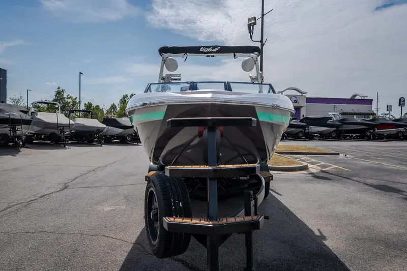 Slide: The Image of 2021 Tigé 21ZX boat on trailer in dealership parking lot under clear sky. - 5